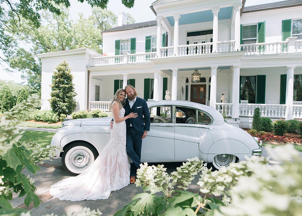 A touch a grandeur for this couple with their old fashioned car in front of our historic wedding venue in Nashville