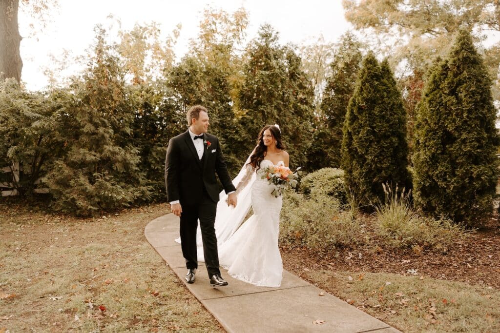 happy couple in wedding gown and tux exploring the grounds of Belle Air, one of the best places to get married in Nashville, TN