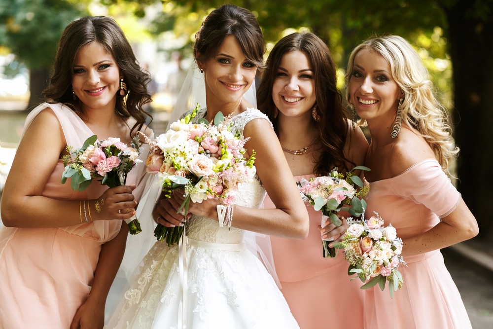 A Bridal party posing for pictures in front of Belle Air Mansion, one of the most beautiful Nashville wedding Venues