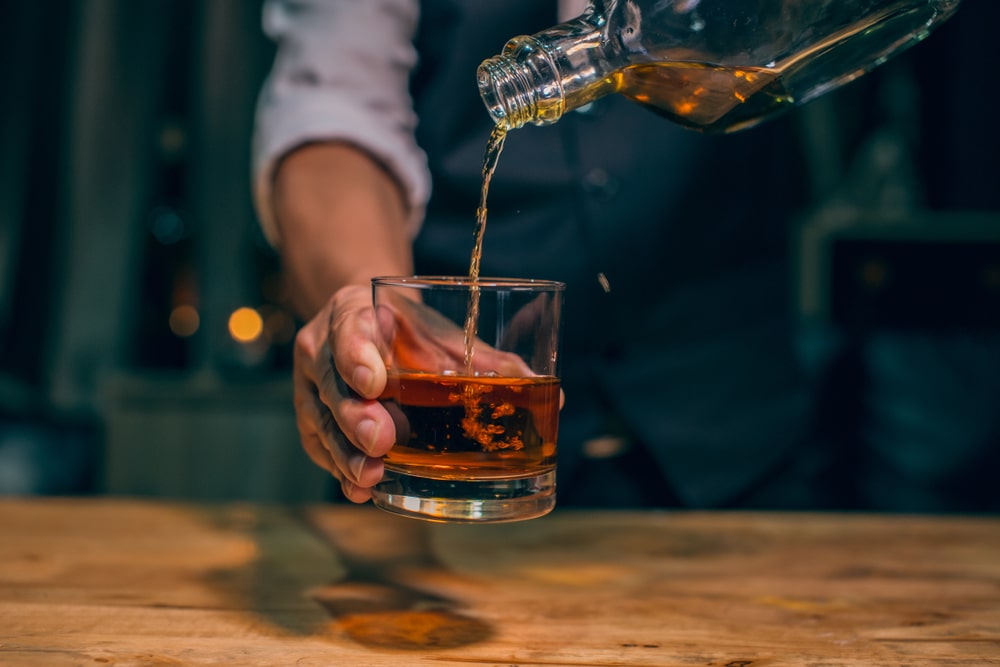Man pouring a tasting on a Nashville Whiskey Tour at top Nashville Distilleries
