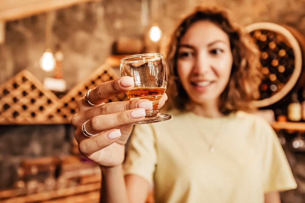 Tennessee Whiskey Trail, a woman tasting a shot of whiskey 